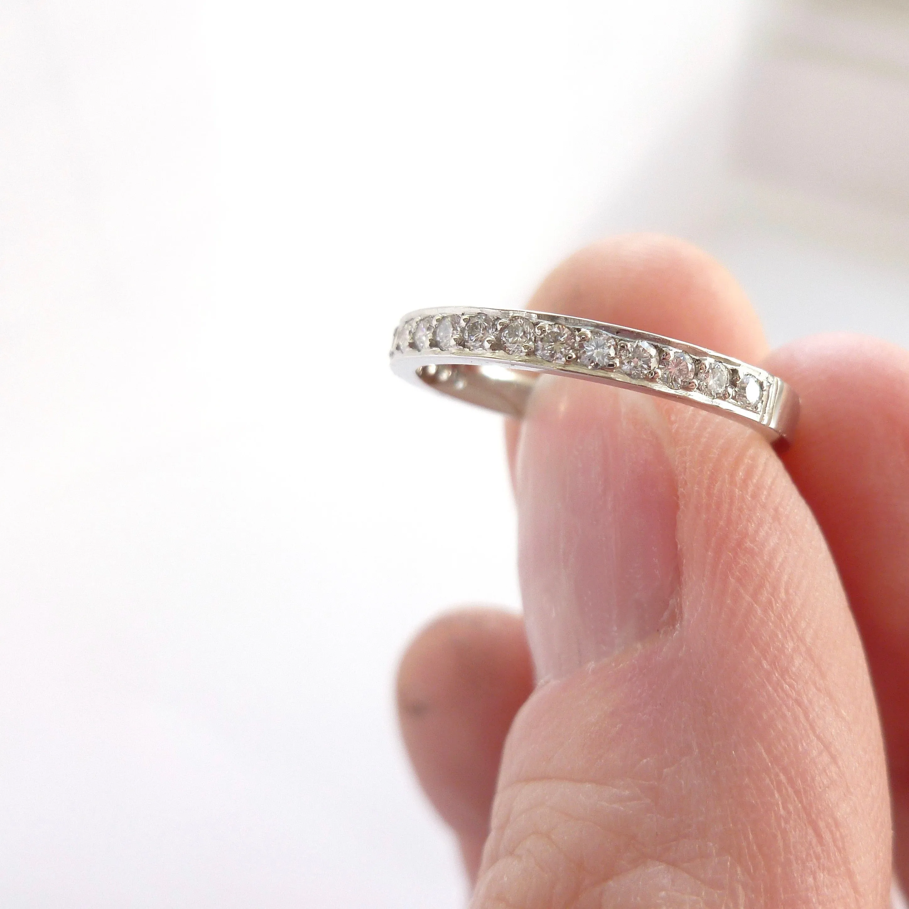 Classic platinum eternity or wedding ring with 17 pave set white diamonds