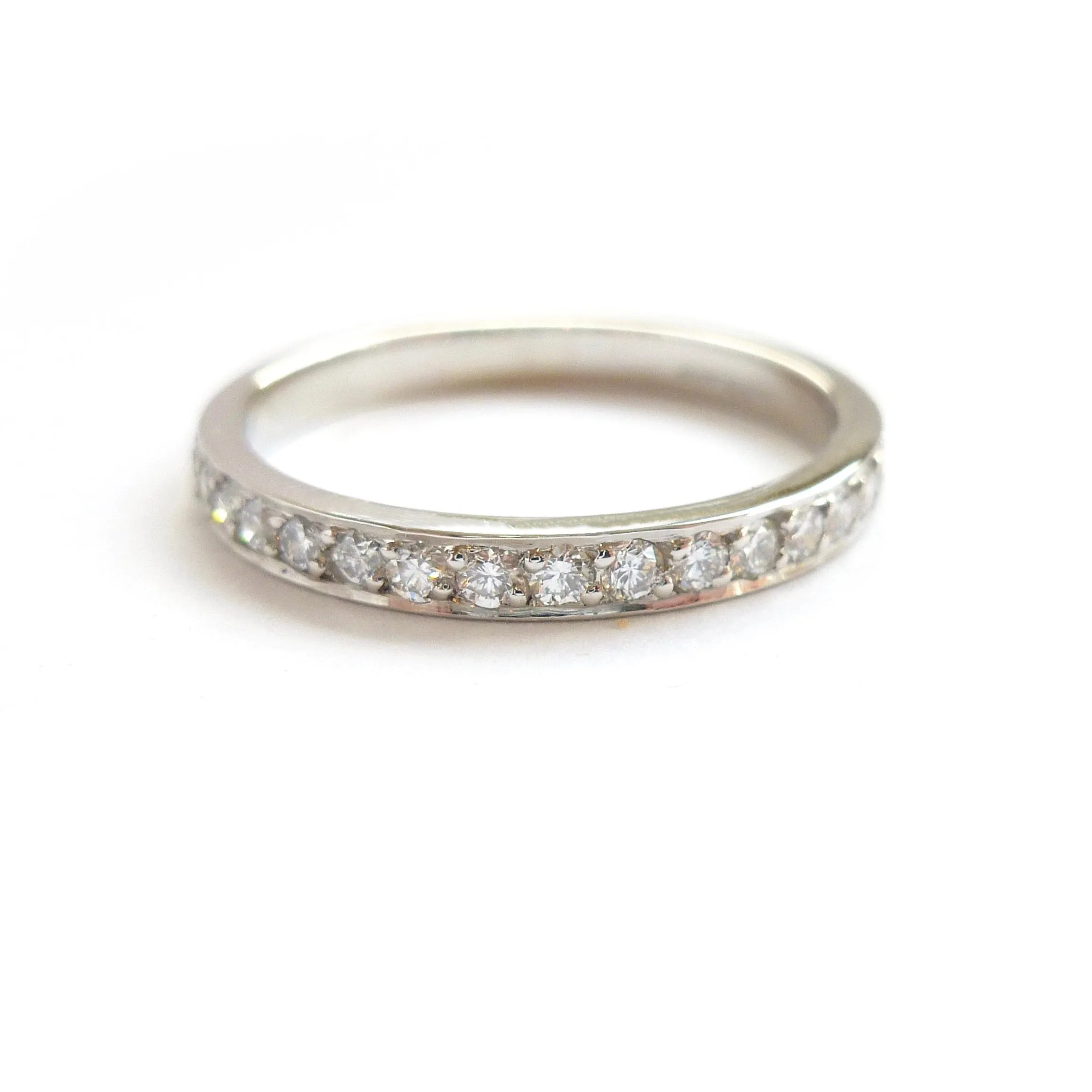 Classic platinum eternity or wedding ring with 17 pave set white diamonds