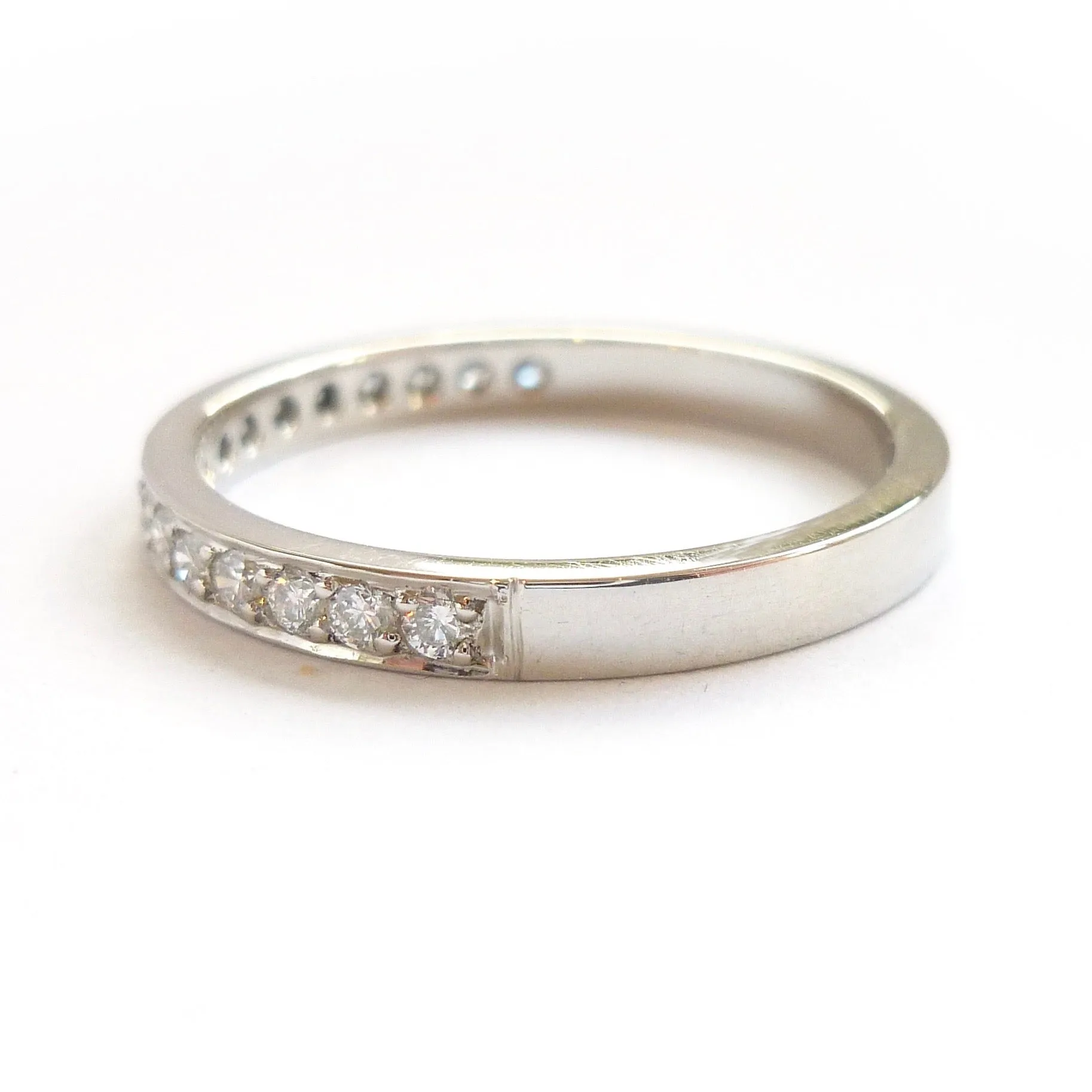 Classic platinum eternity or wedding ring with 17 pave set white diamonds