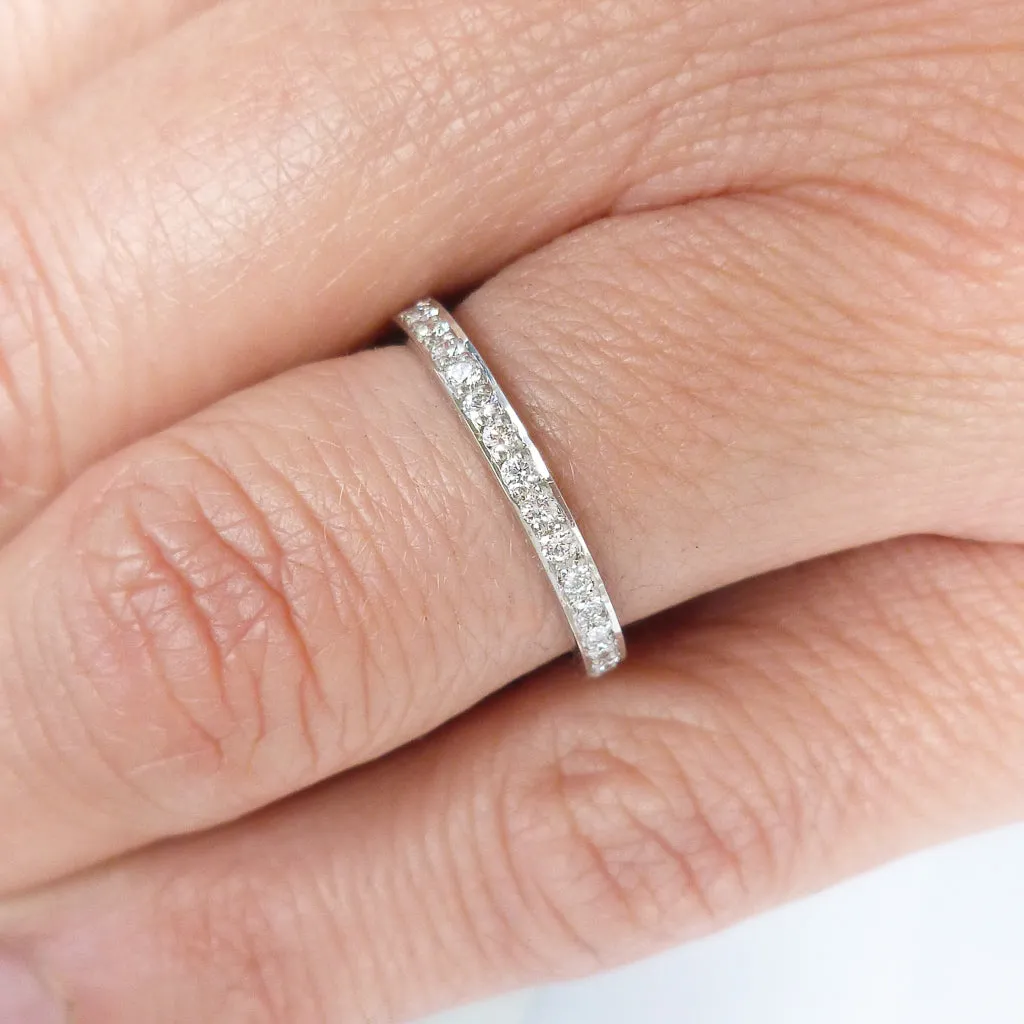 Classic platinum eternity or wedding ring with 17 pave set white diamonds