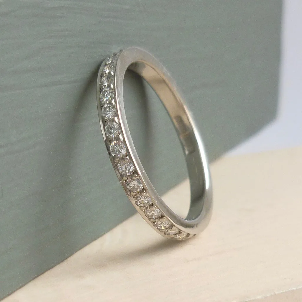 Classic platinum eternity or wedding ring with 17 pave set white diamonds