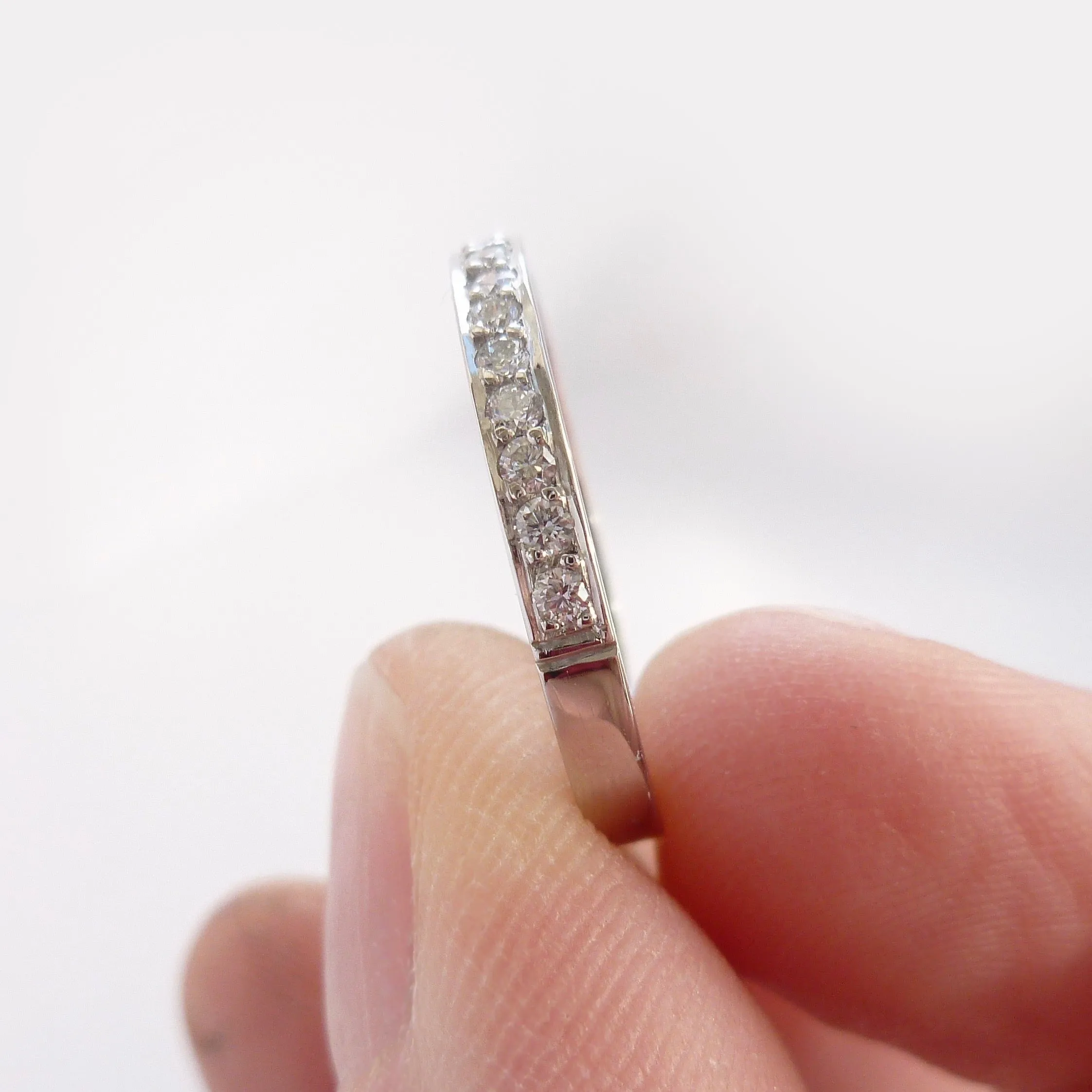 Classic platinum eternity or wedding ring with 17 pave set white diamonds